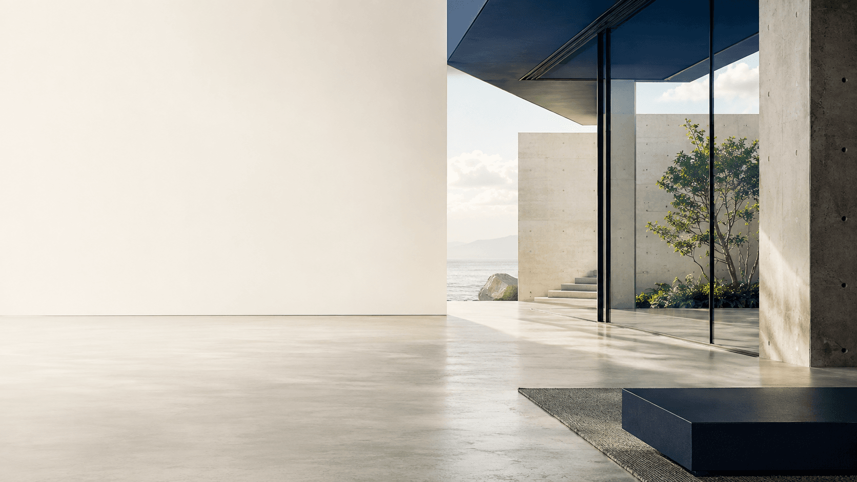 Modern architecture combining glass, concrete, natural light, and a living tree.